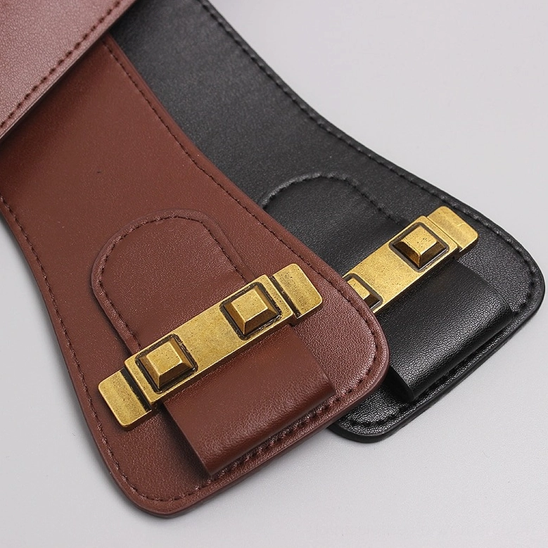 Gothic corset belt end hardware detail with antique gold square buckles and leather panel