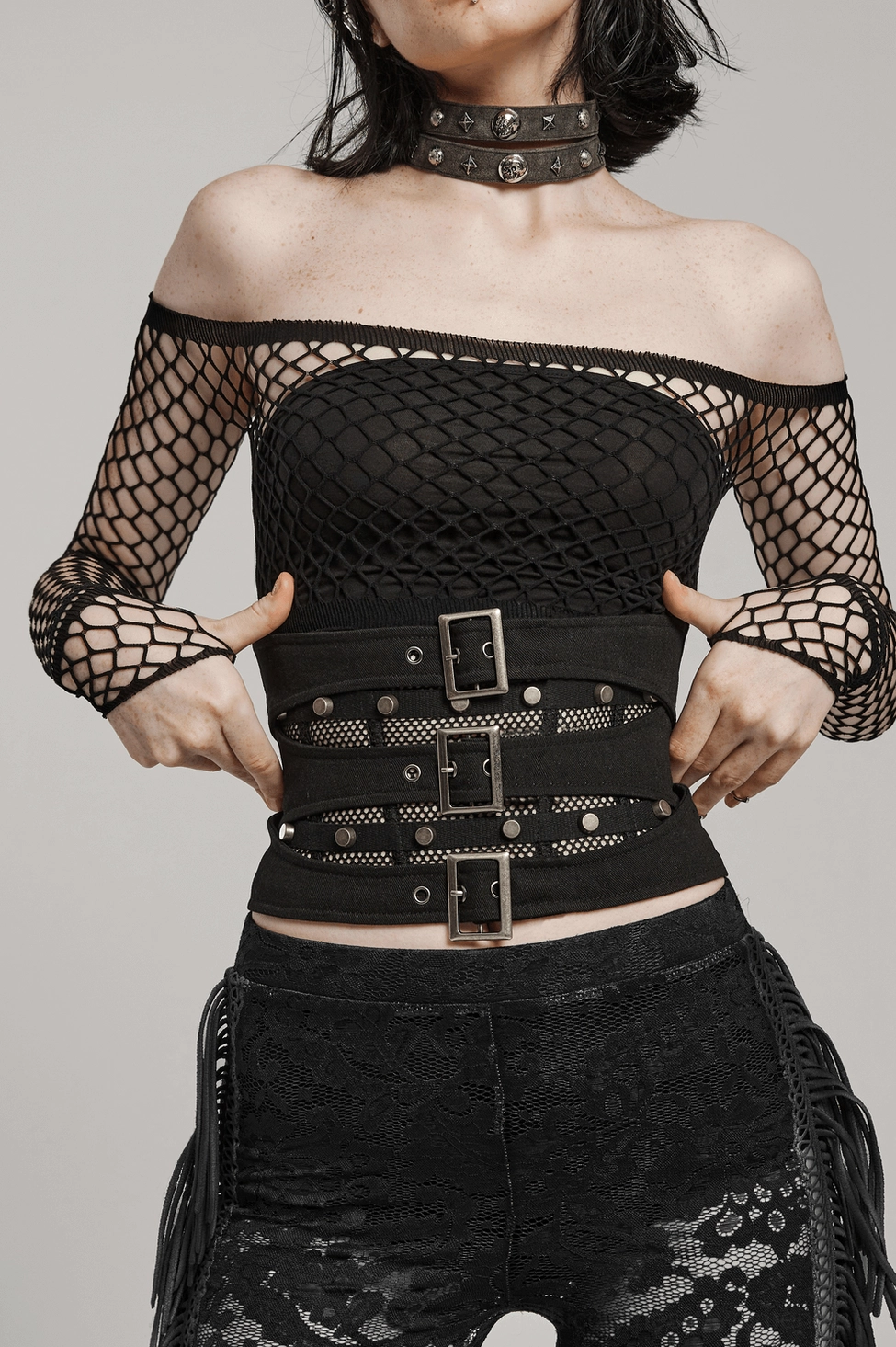 Black gothic corset belt detail view emphasizing metal buckles, industrial aesthetic, and structural corset silhouette design