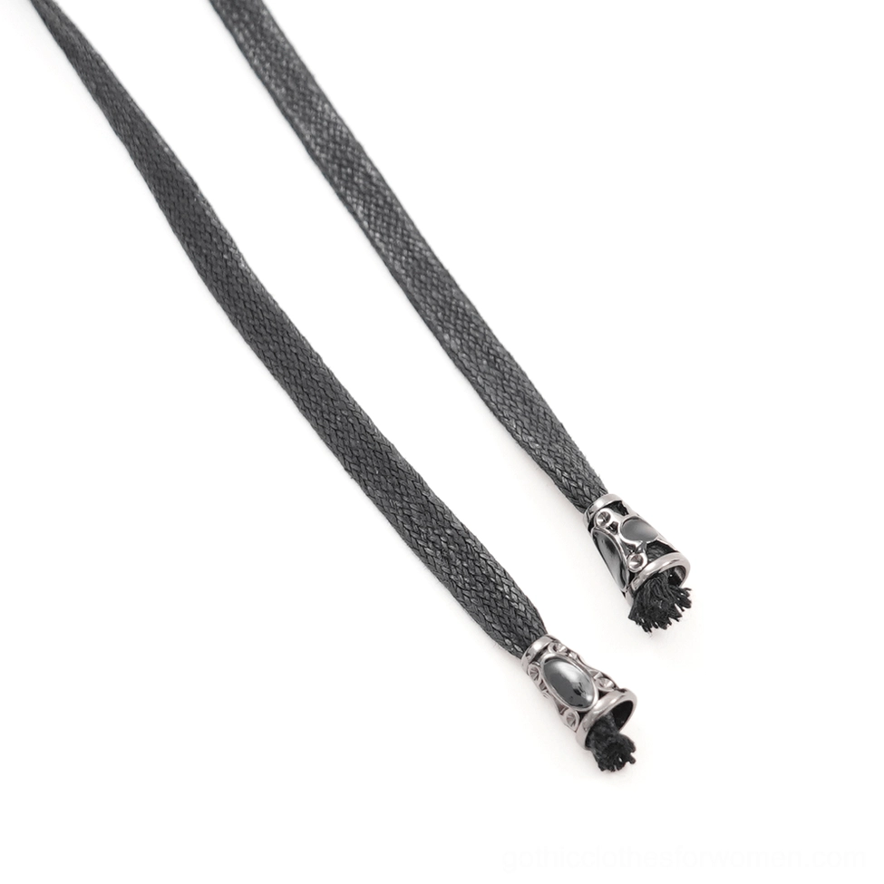 Black gothic corset belt with intricate lace detailing and ruffled trim, alternative fashion styling