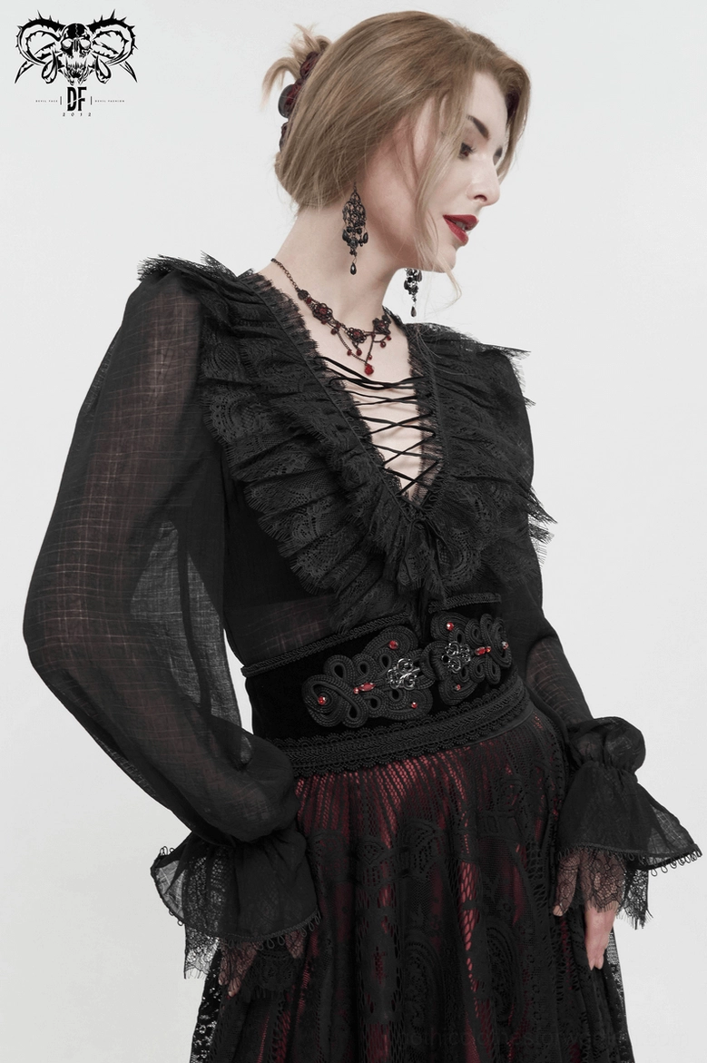 Close-up of lace edge trim on black gothic corset belt showing vintage craftsmanship details
