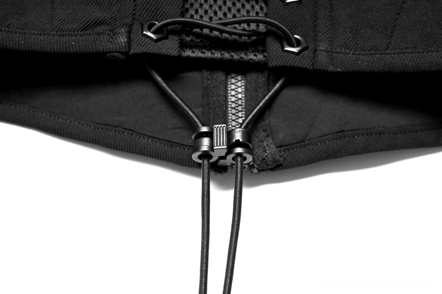 Close-up detail of black corset belt lace-up ties, zipper hardware, and breathable mesh fabric texture
