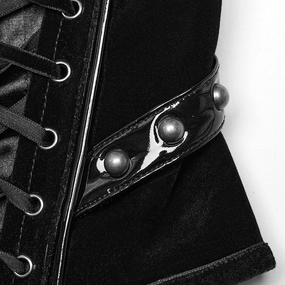 Close-up detail of gothic corset belt side showing metal studs, patent leather strap, rivet hardware, and textural contrast design