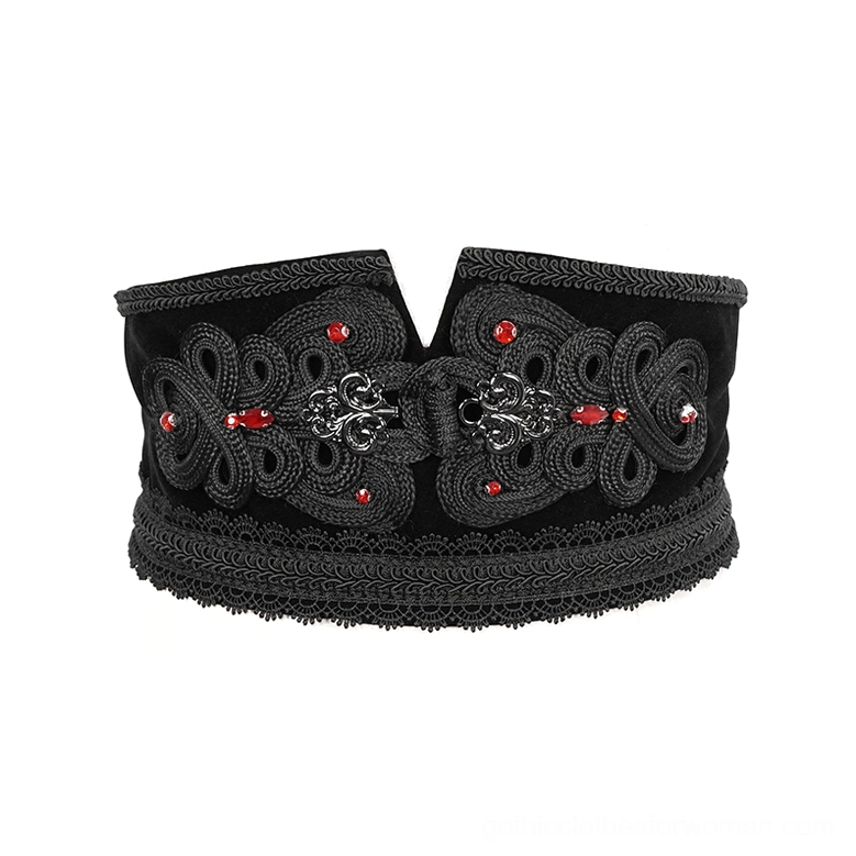 Overhead view of black gothic corset belt showing embossed patterns and lace trim edge details