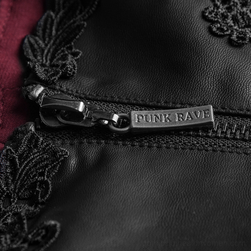 Close-up detail of gothic corset belt zipper hardware with PUNK RAVE branding and dark red fabric lining visible in macro view