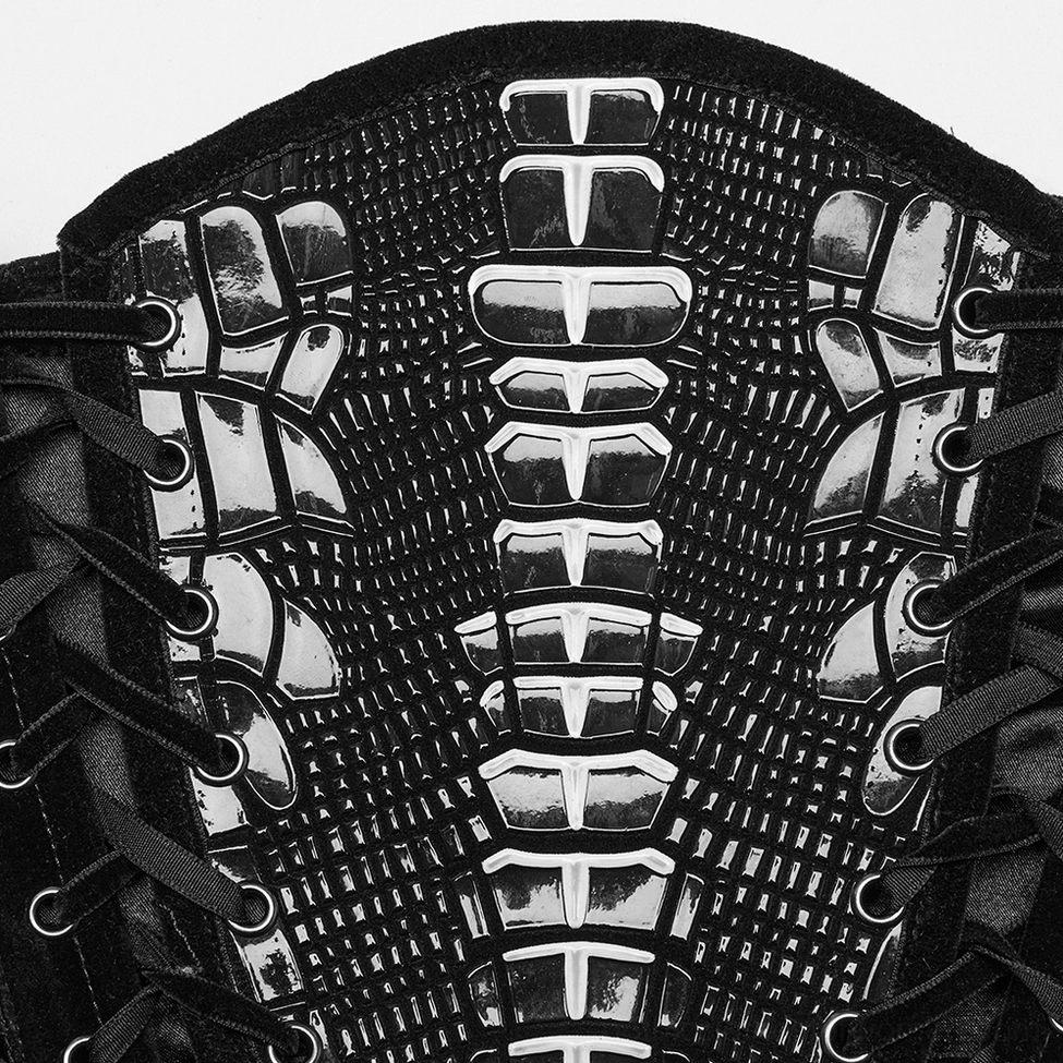 Close-up detail of gothic corset belt front spinal panel showing spine-shaped accents, metal eyelets, and lace-up eyelet precision