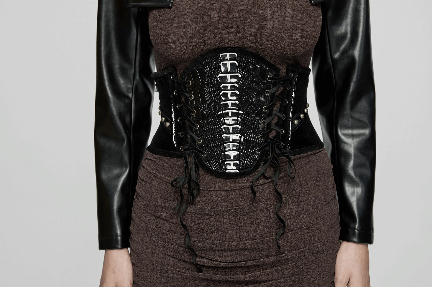 Black velvet and patent leather gothic corset belt detailed view showing material composition, construction quality, and design elements
