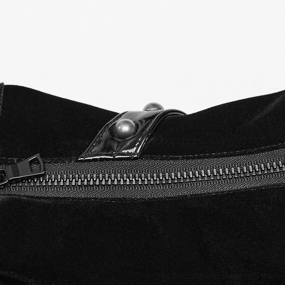 Close-up detail of black velvet gothic corset belt showing metal zipper closure, studded patch accents, and material texture quality