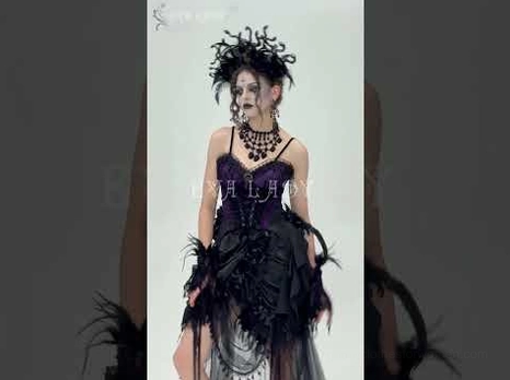 Close-up detail of gothic corset bust area with black floral lace and gemstone ornamental accents