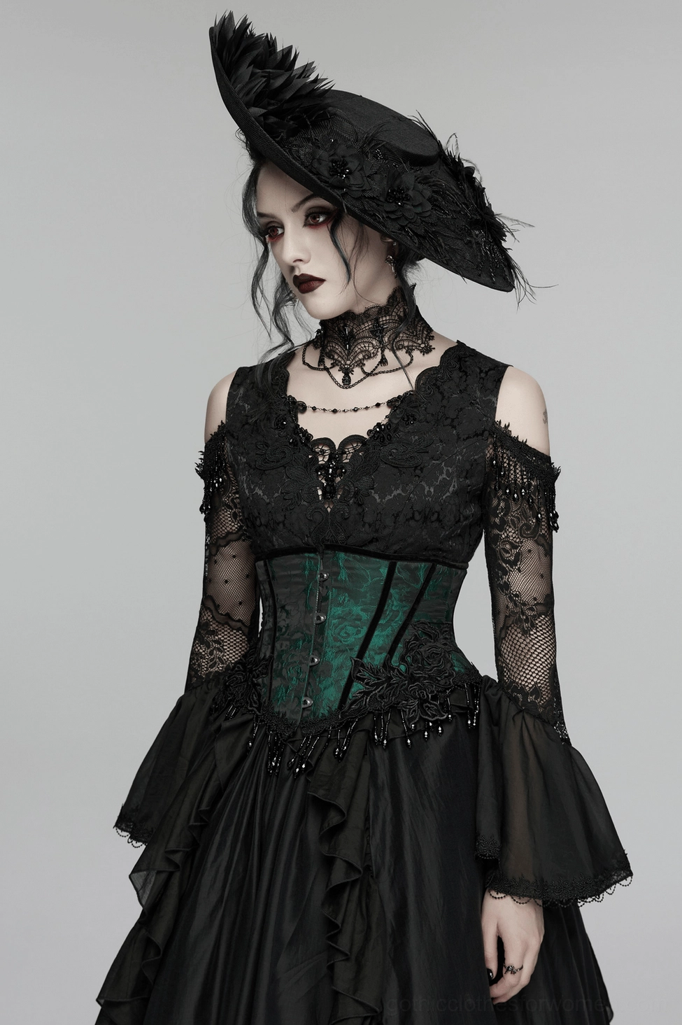 Complete underbust corset detail showcasing green rose jacquard pattern, beaded fringe pendants, and hand-sewn embellishments