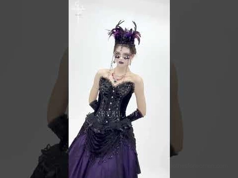Gothic corset styled with feathered headpiece and alternative fashion accessories on model