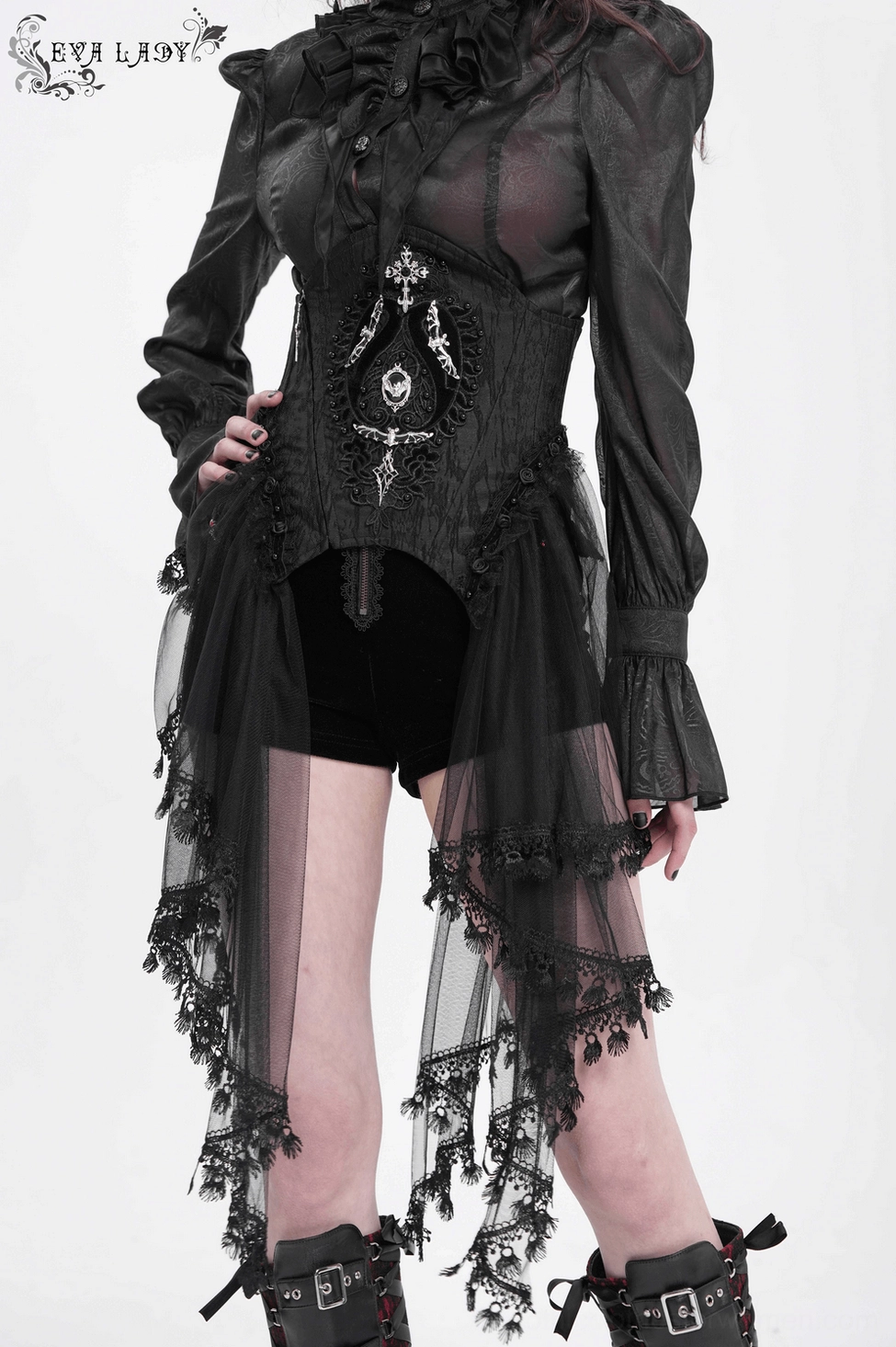 Black gothic underbust corset flat lay showing intricate lace pattern, tulle layers, and metal gothic embellishments