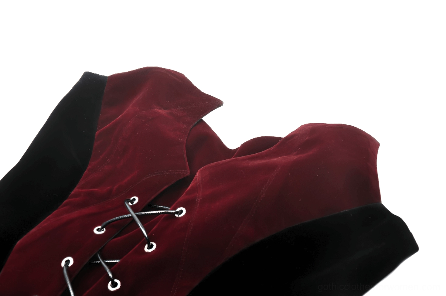 Gothic velvet corset neckline close-up, wine red fabric and metal eyelet lace-up detail in sharp focus