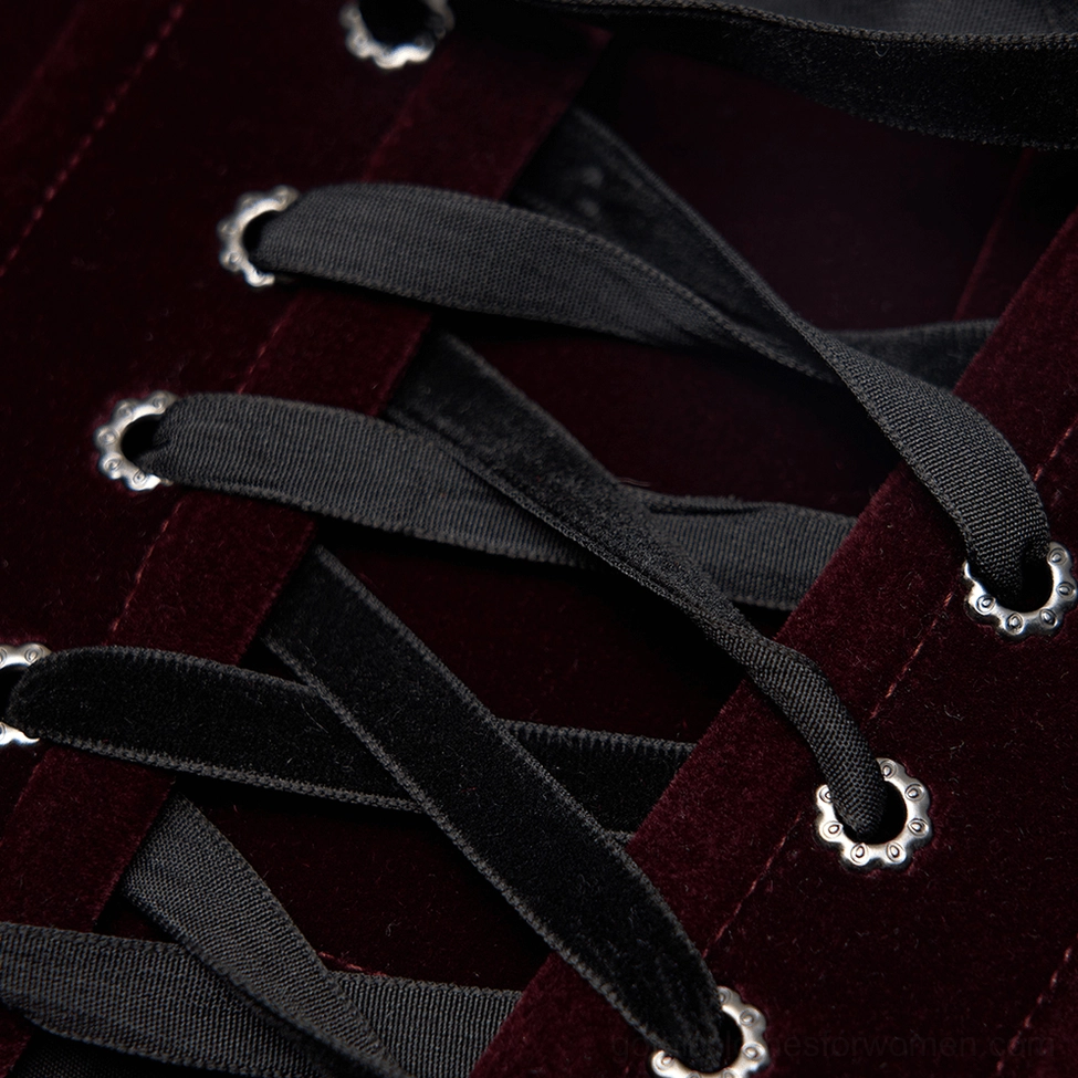 Close-up of front lace-up mechanism with metal grommets on wine red velvet gothic corset belt