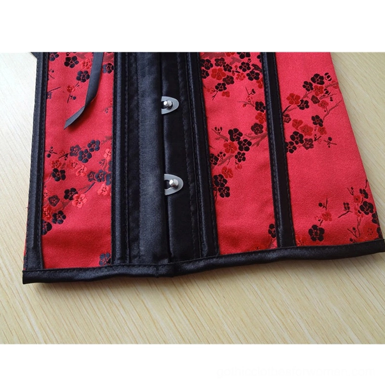 Red gothic corset front fastening detail showing silver metal hook closures and black satin center strip on close-up flat view