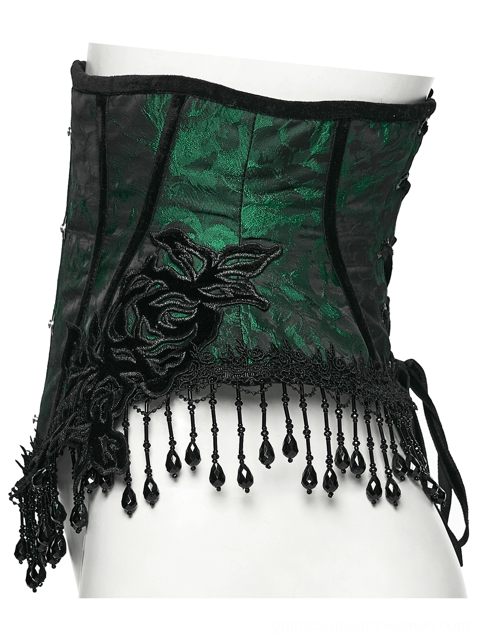 Side profile flat lay of emerald gothic underbust corset displaying black rose embroidery and hand-beaded tassel hem detail
