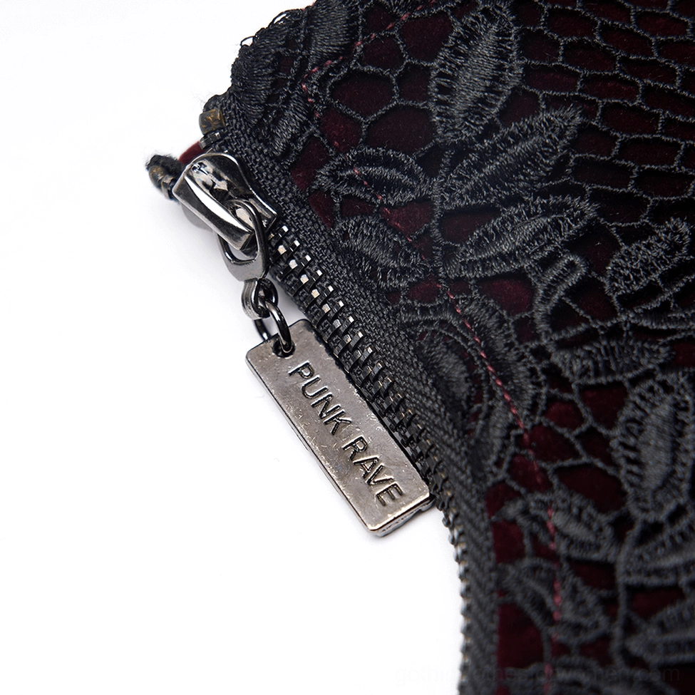 Texture detail shot of wine red velvet and black lace overlay on gothic corset belt