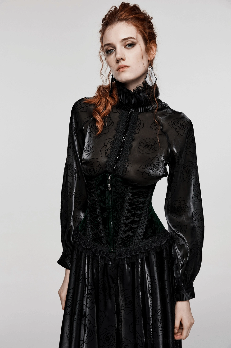Black velveteen gothic corset detail view showcasing premium fabric texture, floral pattern, lace-up construction, and refined craftsmanship