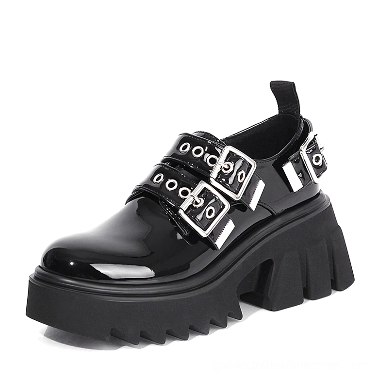 Black patent leather gothic loafers with shiny finish, dual metal buckle hardware, three-quarter view highlighting high-gloss upper and platform sole detail