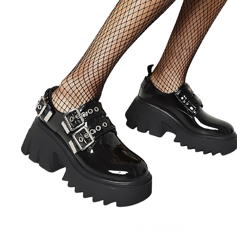 Side profile of gothic platform loafers on model with fishnet hosiery, matte black leather upper with dual buckles and heavy platform sole