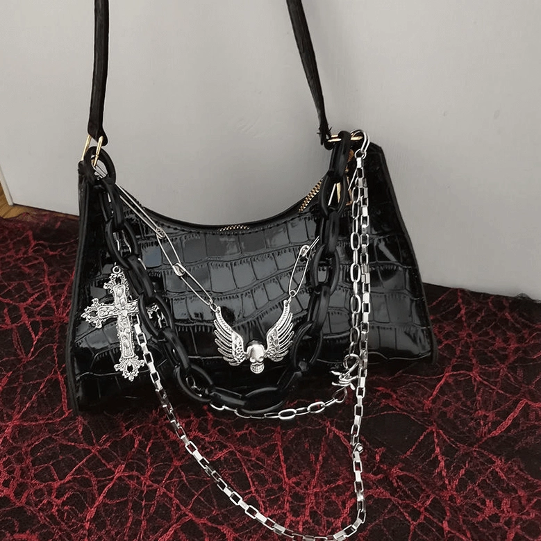 Punk gothic crocodile pattern shoulder bag with metal chain straps and skull motif, oblique angle showcase