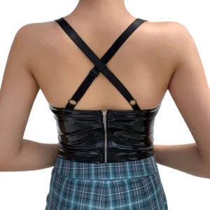 Back view of black patent leather crop cami displaying crisscross harness straps and rear zipper closure