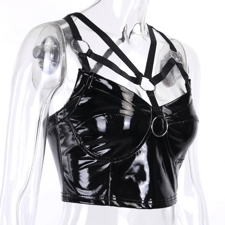 Side-back view of black patent leather crop cami showing crisscross harness straps and glossy PU material