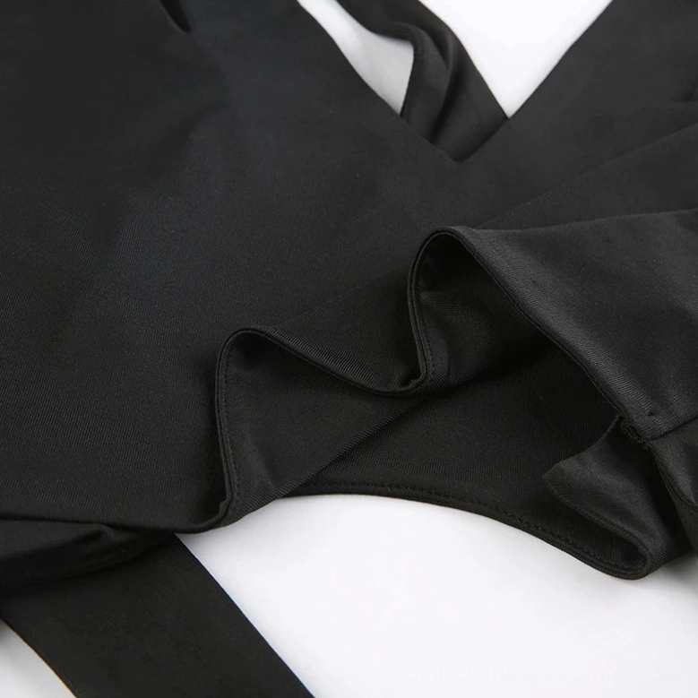 Close-up detail of smooth matte black polyester-spandex fabric texture with folded seams - demonstrates premium material quality