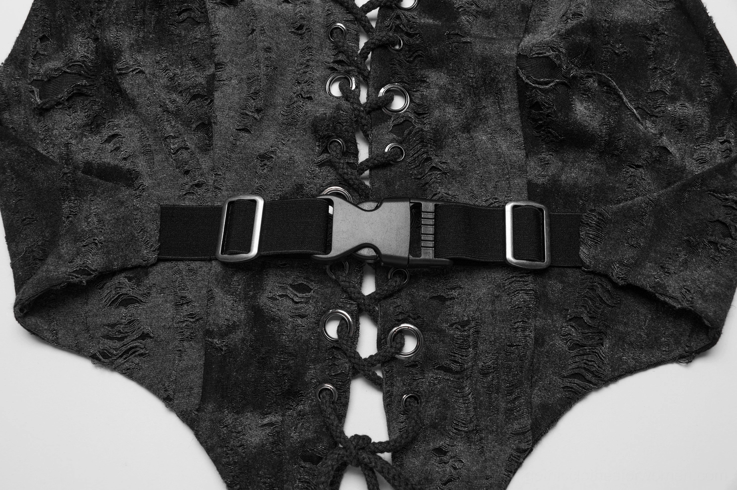 Close-up detail of gothic crop top back strap hardware featuring plastic release buckle, elastic waist strap, and distressed fabric edge