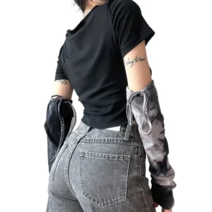 Back view of black gothic crop top with exposed raw seams paired with denim