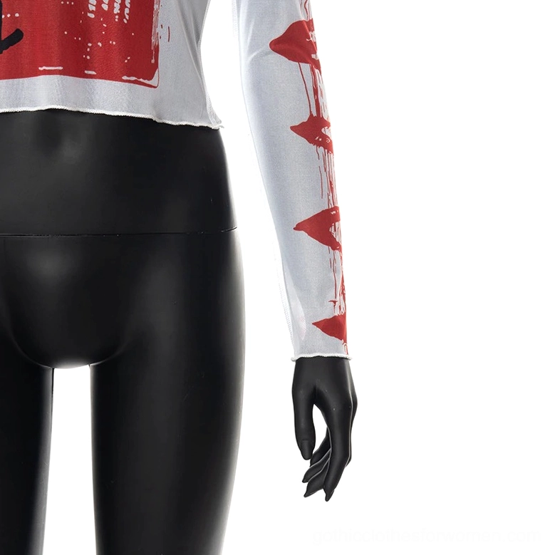 Close-up side detail of gothic crop top showing raw edge hem, sheer mesh texture, and lip print sleeve embellishments
