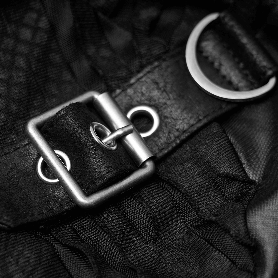 Close-up detail of silver metal hardware including D-ring buckle and faux leather strap on gothic top