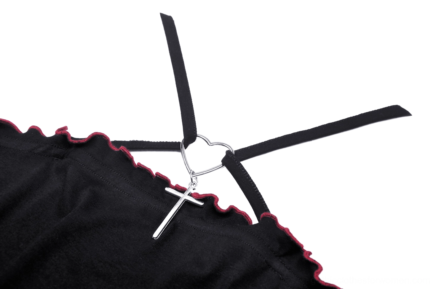 Close-up detail of batwing gothic crop top showing heart buckle, cross pendant, and ruffled trim
