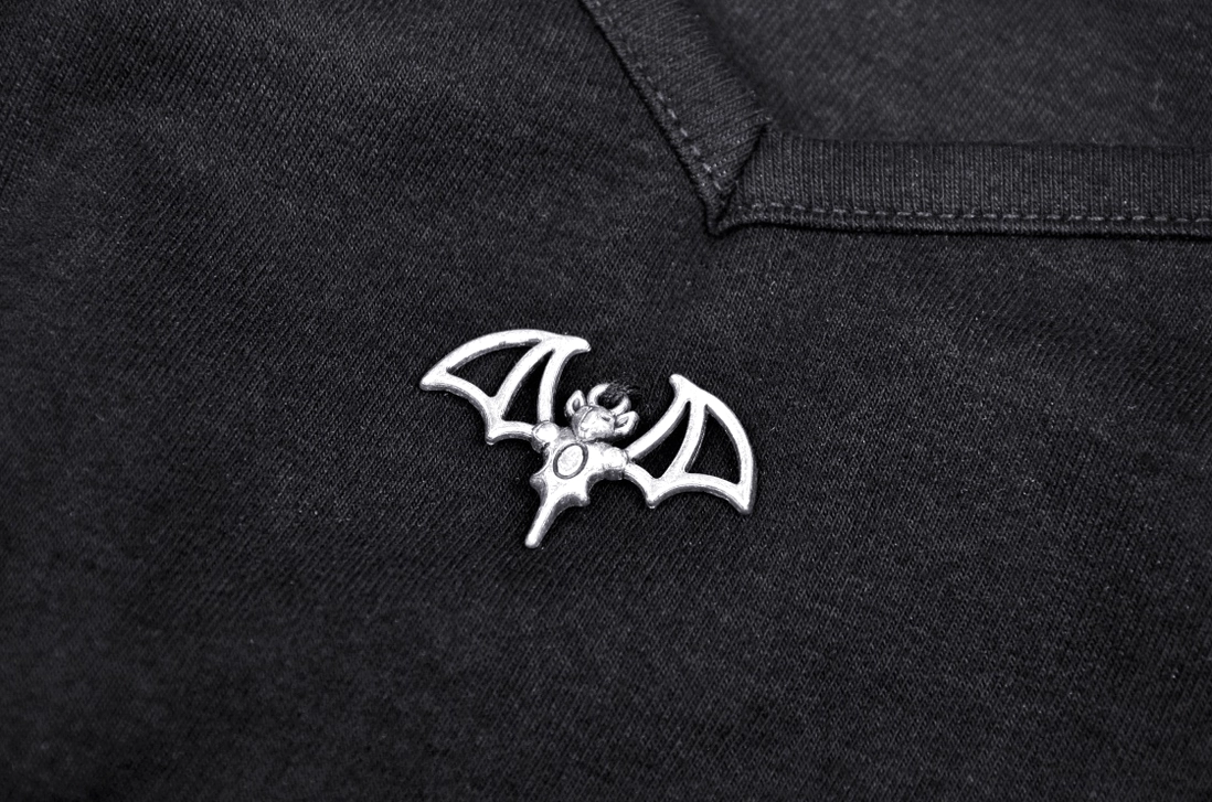 Close-up detail of gothic crop top sweetheart neckline, side lace fasteners and quality brand label
