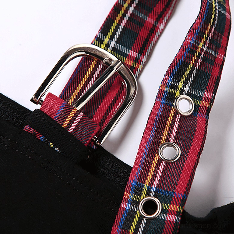 Close-up detail of gothic crop top neckline showing metal buckle strap, red tartan star patch, and patchwork construction