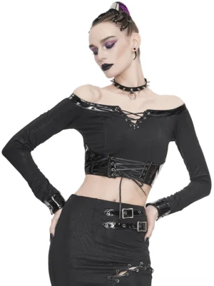 Black off-shoulder gothic crop top with lace-up front and patent leather trim on model with purple braided hair, three-quarter front view