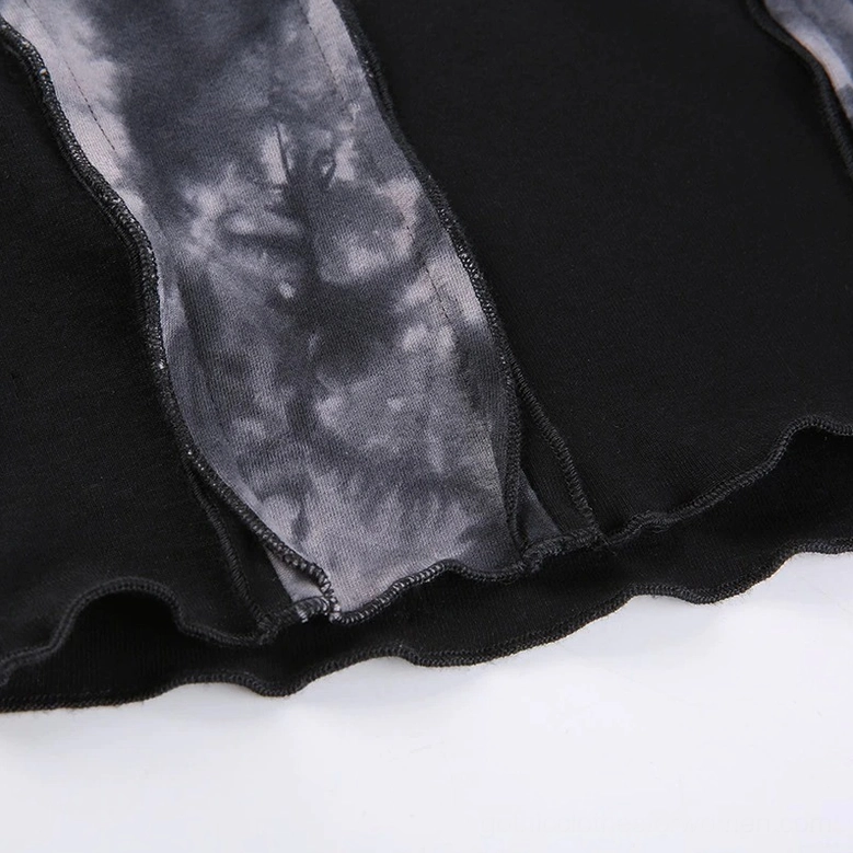 Detail of exposed raw seams and ruffled cropped hem on gothic top with two-tone fabric