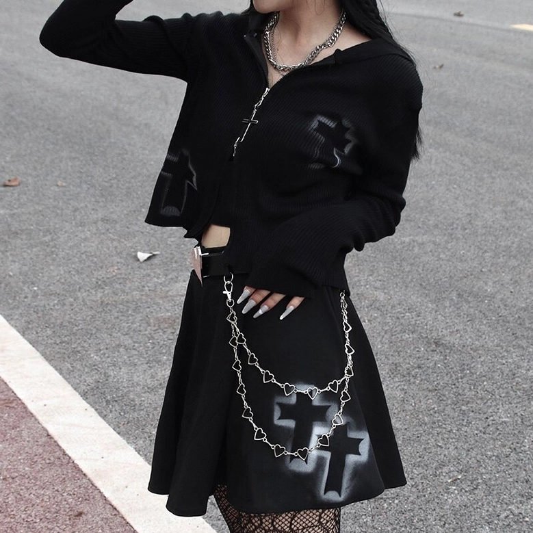 Rear view of gothic crop zip sweater worn outdoors, showing long sleeve fit and cross print details on skirt