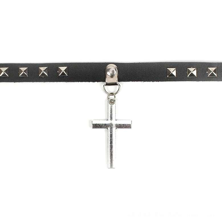 Flat lay top-down view of black gothic cross choker with dangling silver cross pendant