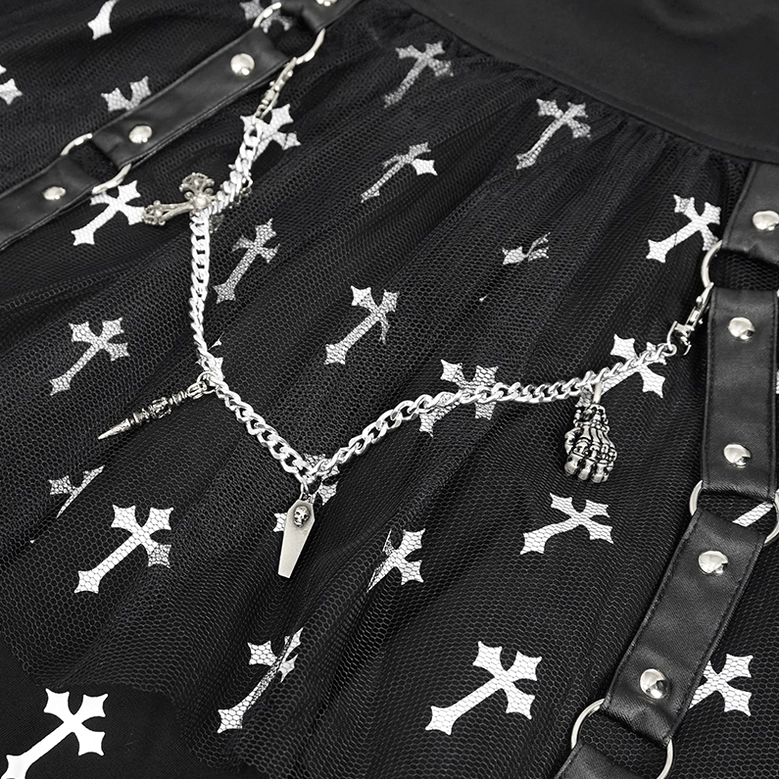 Side profile detail of black gothic cross print knitted skirt highlighting tulle mesh overlay, chain embellishment, and cross print motifs