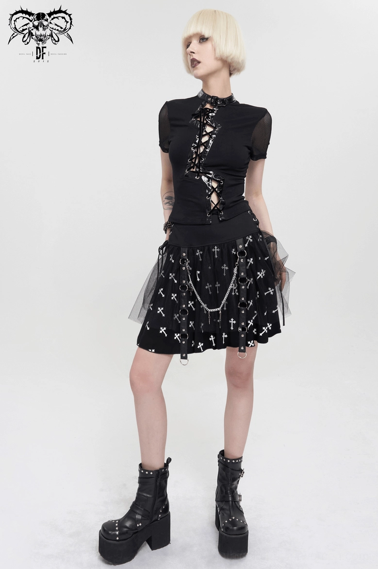Complete gothic outfit featuring black cross print skirt paired with lace-up goth top and platform boots on blonde model - three-quarter side angle