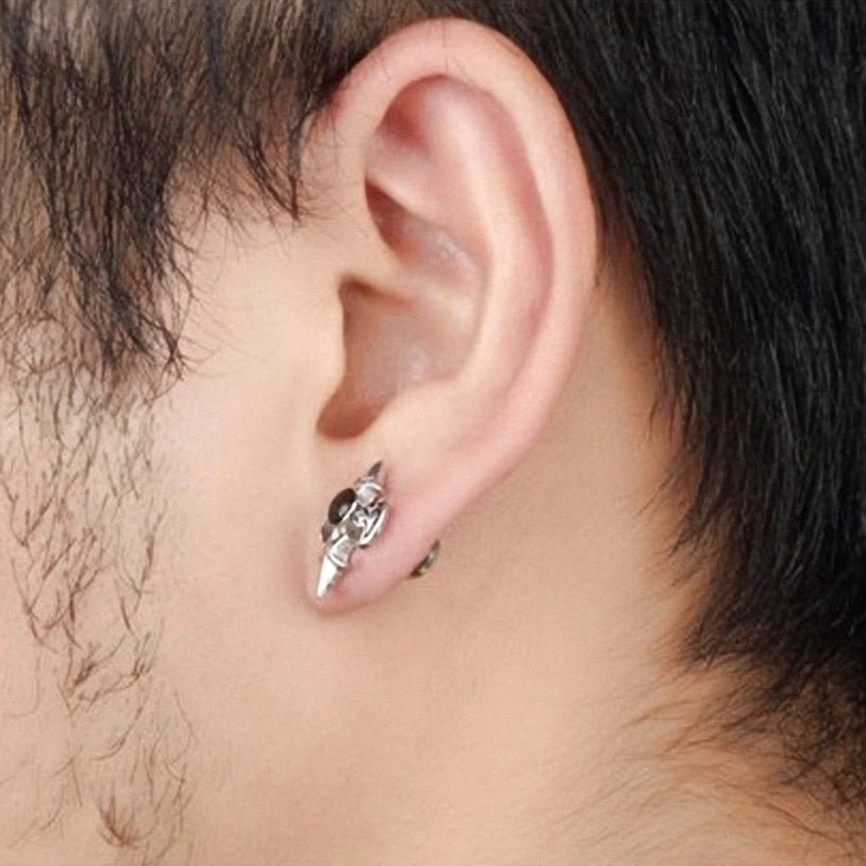 Gothic cross stud earrings worn on earlobe close-up - real life wearing effect and comfort demonstration