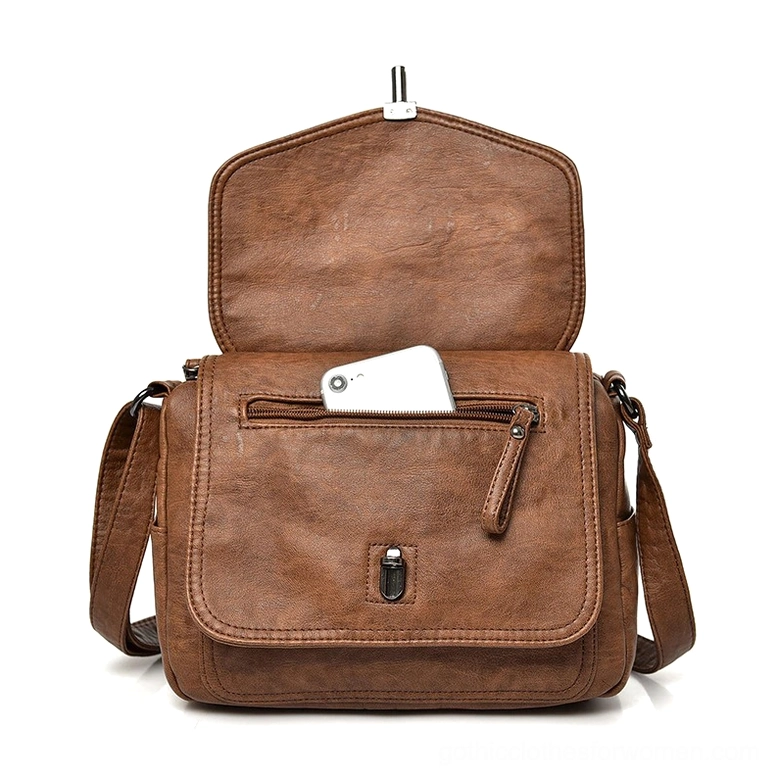 Interior of gothic crossbody handbag showing zipper pocket and lining, open view