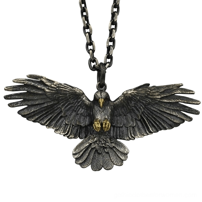 Blackened silver crow pendant necklace front view with spread wings and golden talons, vintage gothic jewelry on flat display