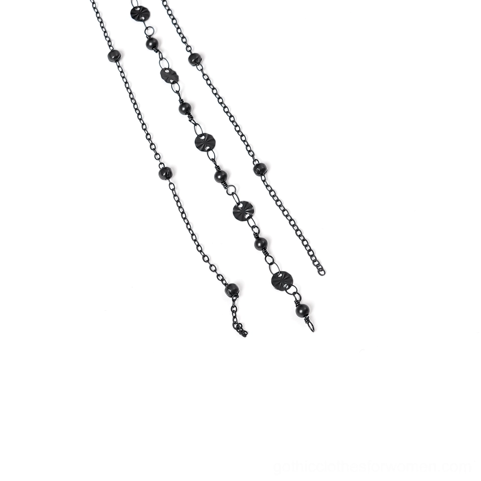 Side close-up detail of hanging chain ornaments including cross and moon pendants with beaded metal chains on gothic crown
