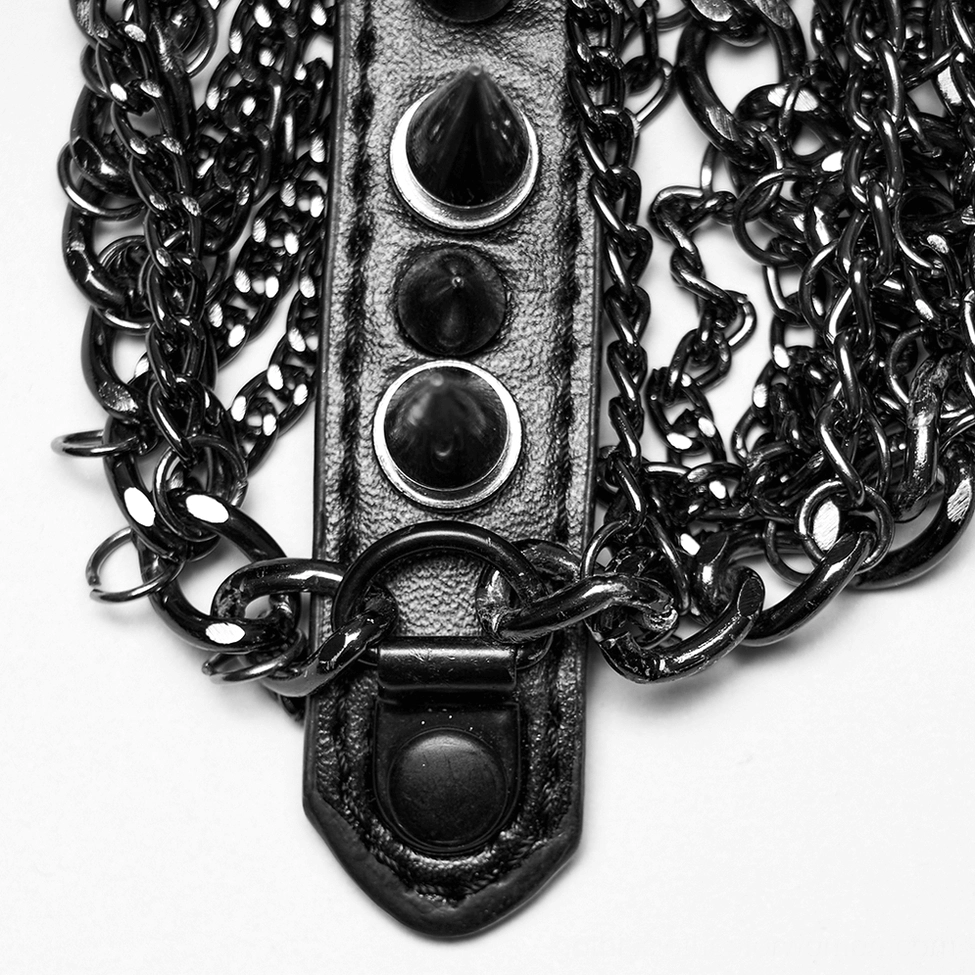 Flat lay close-up detail of gunmetal chains, leather strap base, metal spikes and rivets of gothic crown headpiece