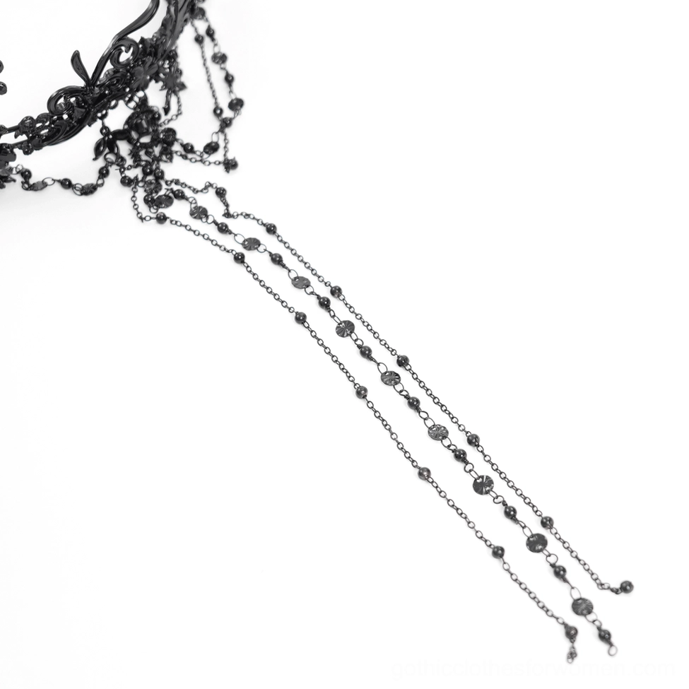 Rosary-style black beaded chains with dangling cross accents from gothic crown, flat lay close-up detail