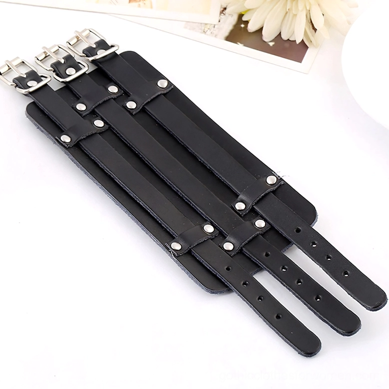 Flat lay view of unassembled gothic cuff bracelet straps showing three adjustable leather components with silver buckles and metal fittings