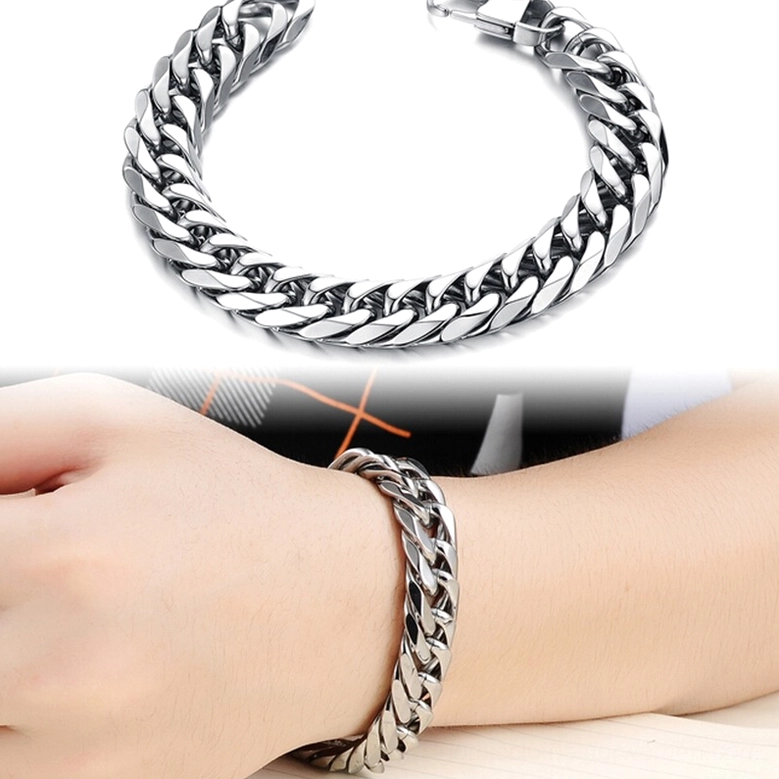 Compact stainless steel gothic curb chain bracelet from side overhead angle featuring secure lobster clasp closure