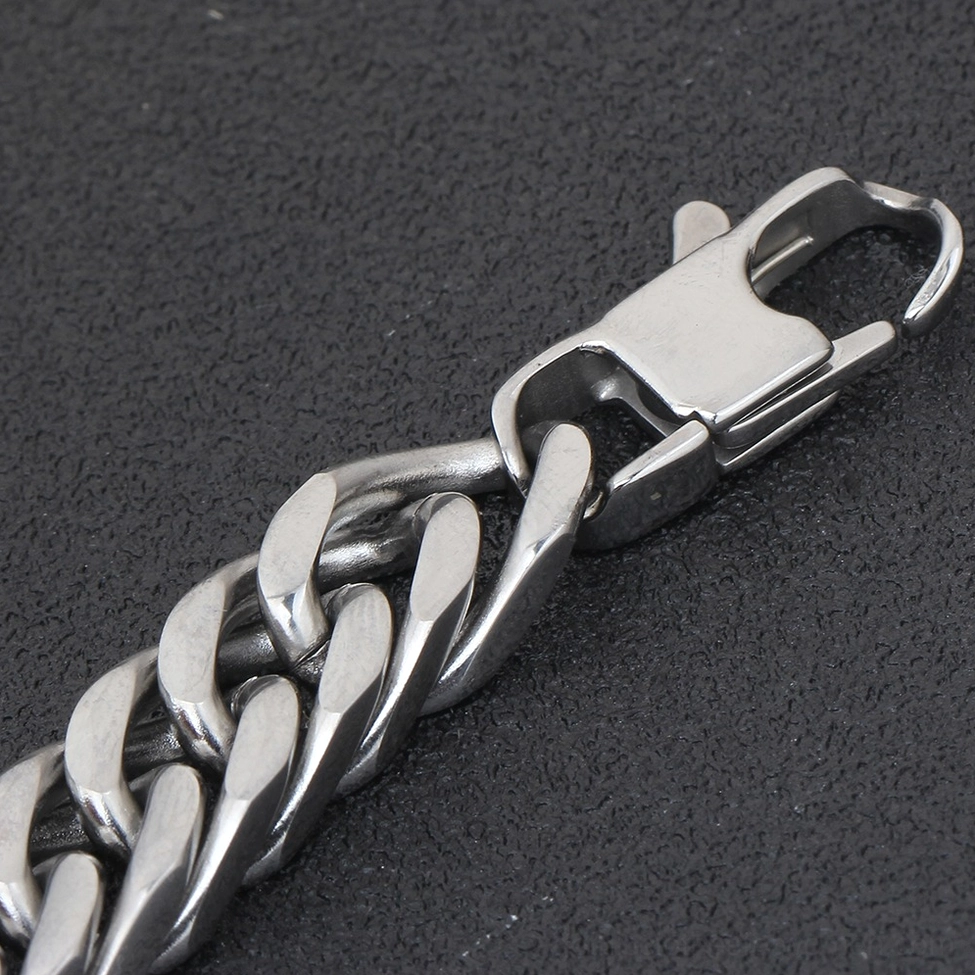 Macro photography of gothic bracelet lobster claw clasp hardware showing polished stainless steel construction and reliable closure mechanism