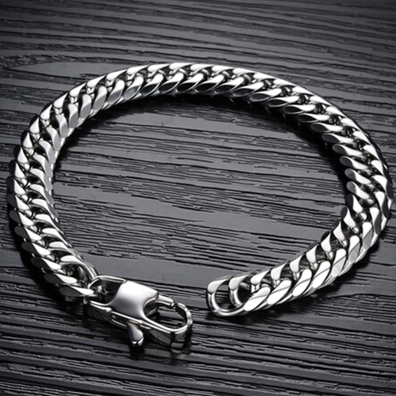 Gothic curb chain bracelet displayed flat on dark wood grain surface showing open clasp and full chain loop configuration